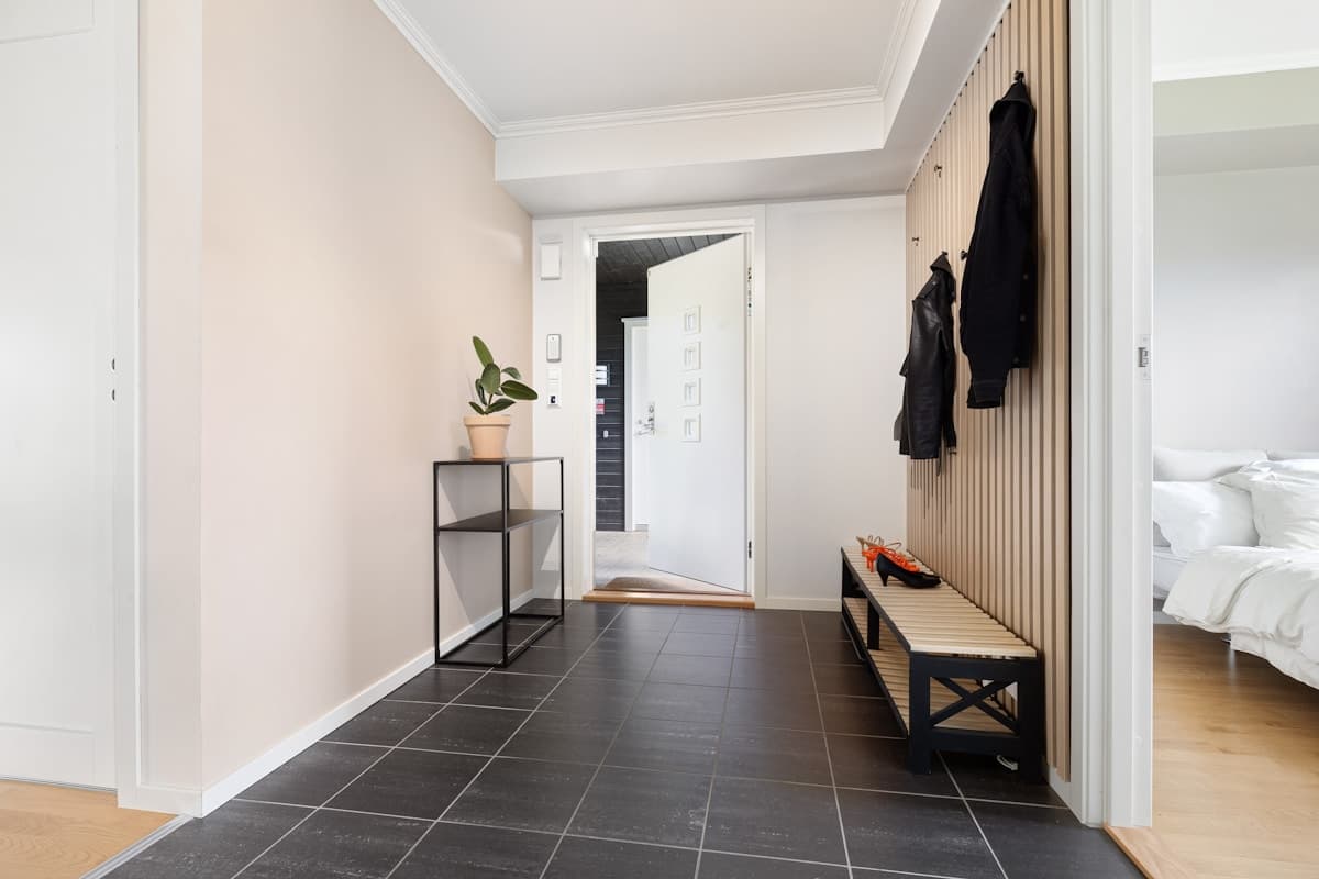 Minimal warm entryway with organized storage and natural textures.